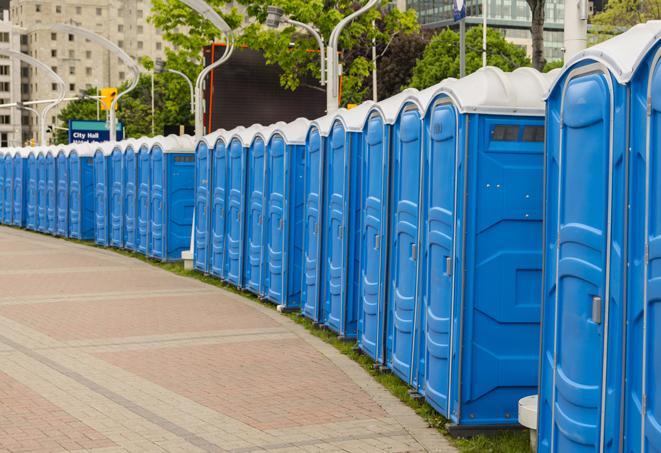 a row of portable restrooms at an outdoor special event, ready for use in Bogota, NJ